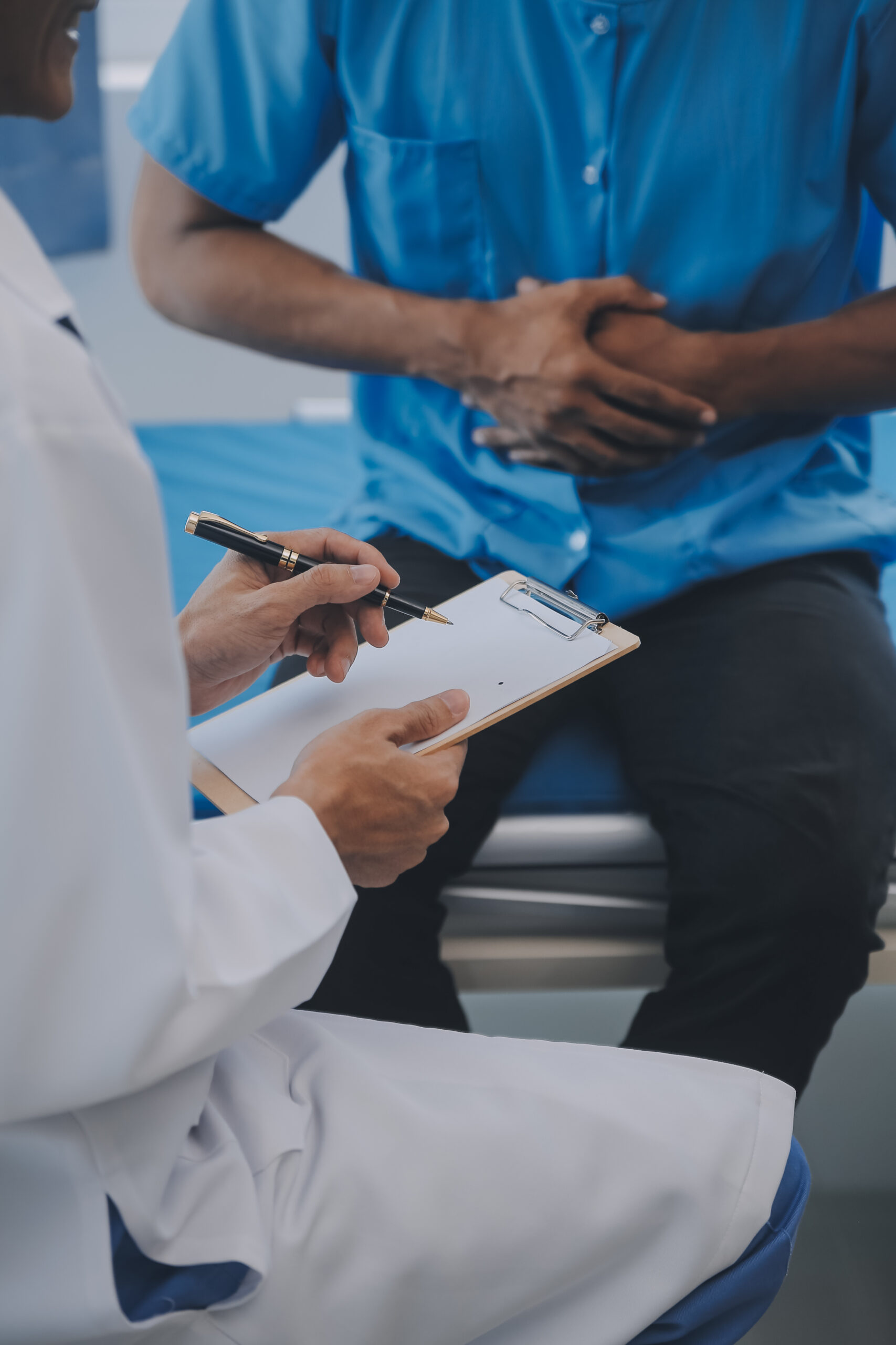 Doctor and patient discussing perfect health exam results. Frien